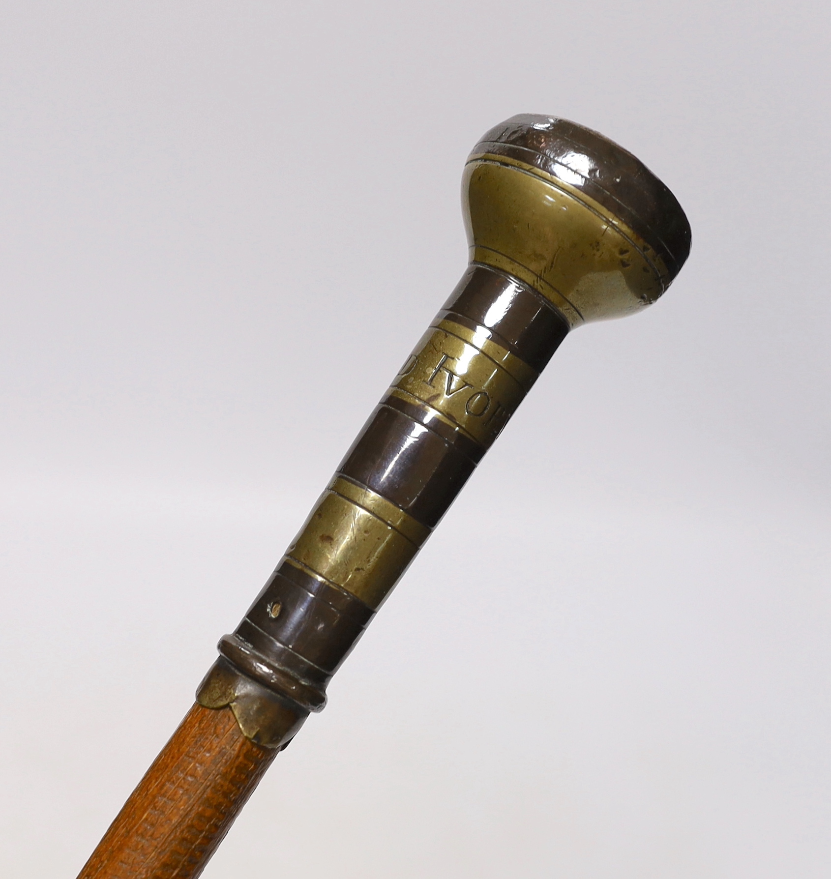 A walking cane, with engraved copper and brass handle, ‘Edmund Ivory, George King, 1741’, length 100cm